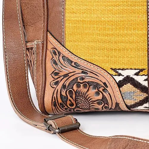 Bohemian brown leather hand-tooled sling bag with yellow Aztec saddle blanket fabric and floral carvings.