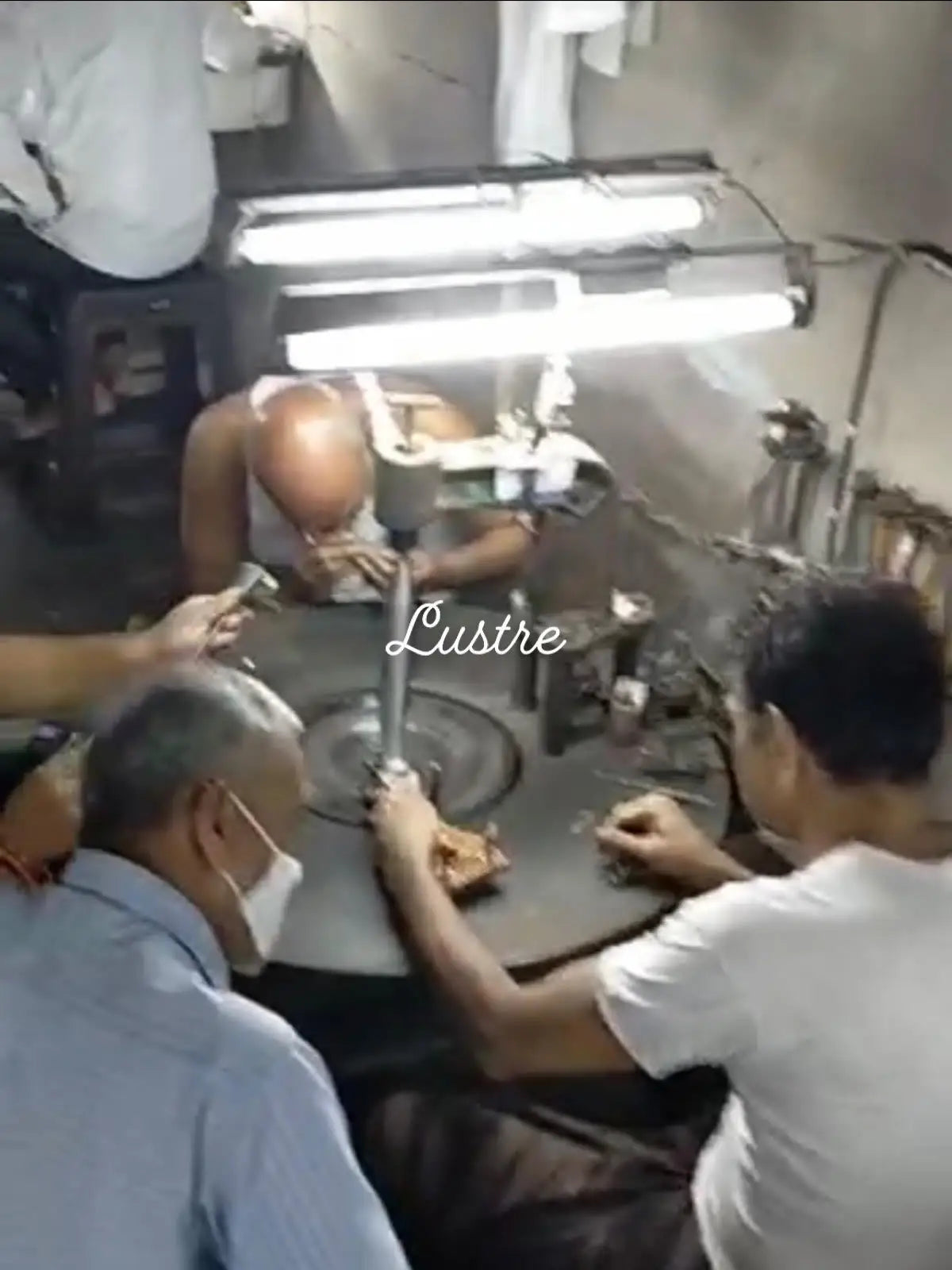 Jewelry manufacturing bench with tools and workers preparing gemstone stringing
