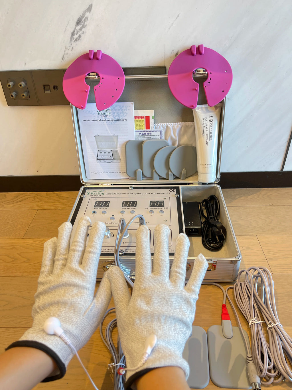 DDS bioelectrical body therapy massager kit with conductive gloves, electrodes, and control unit in a carry case.