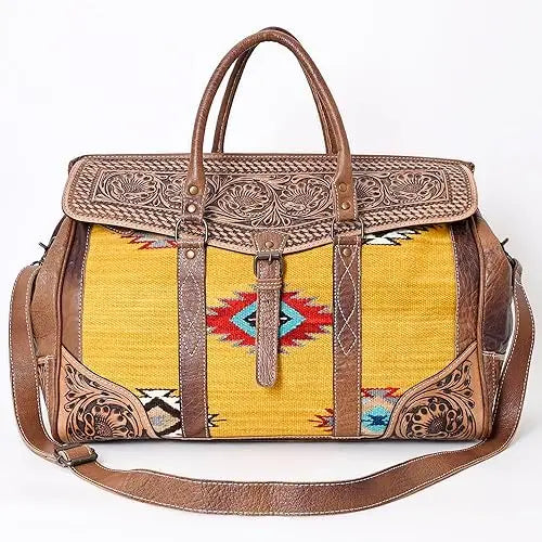 Bohemian trunk bag featuring yellow Aztec saddle blanket fabric and hand-tooled brown leather with floral accents.