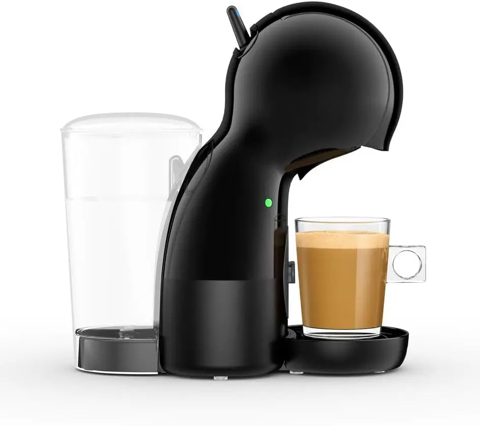 Black Nescafé Dolce Gusto coffee pod machine with clear water tank and glass of espresso on a white background.