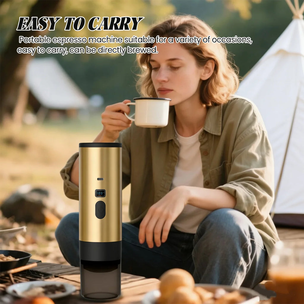 Gold portable espresso maker for camping with digital display and black base, used by woman in outdoor setting.