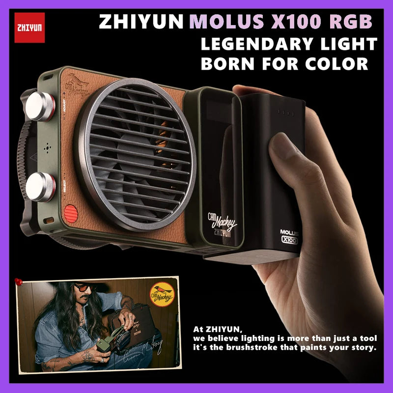 MOLUS X100 RGB portable video light with tan faux leather, green frame, and black cooling fan held in one hand.
