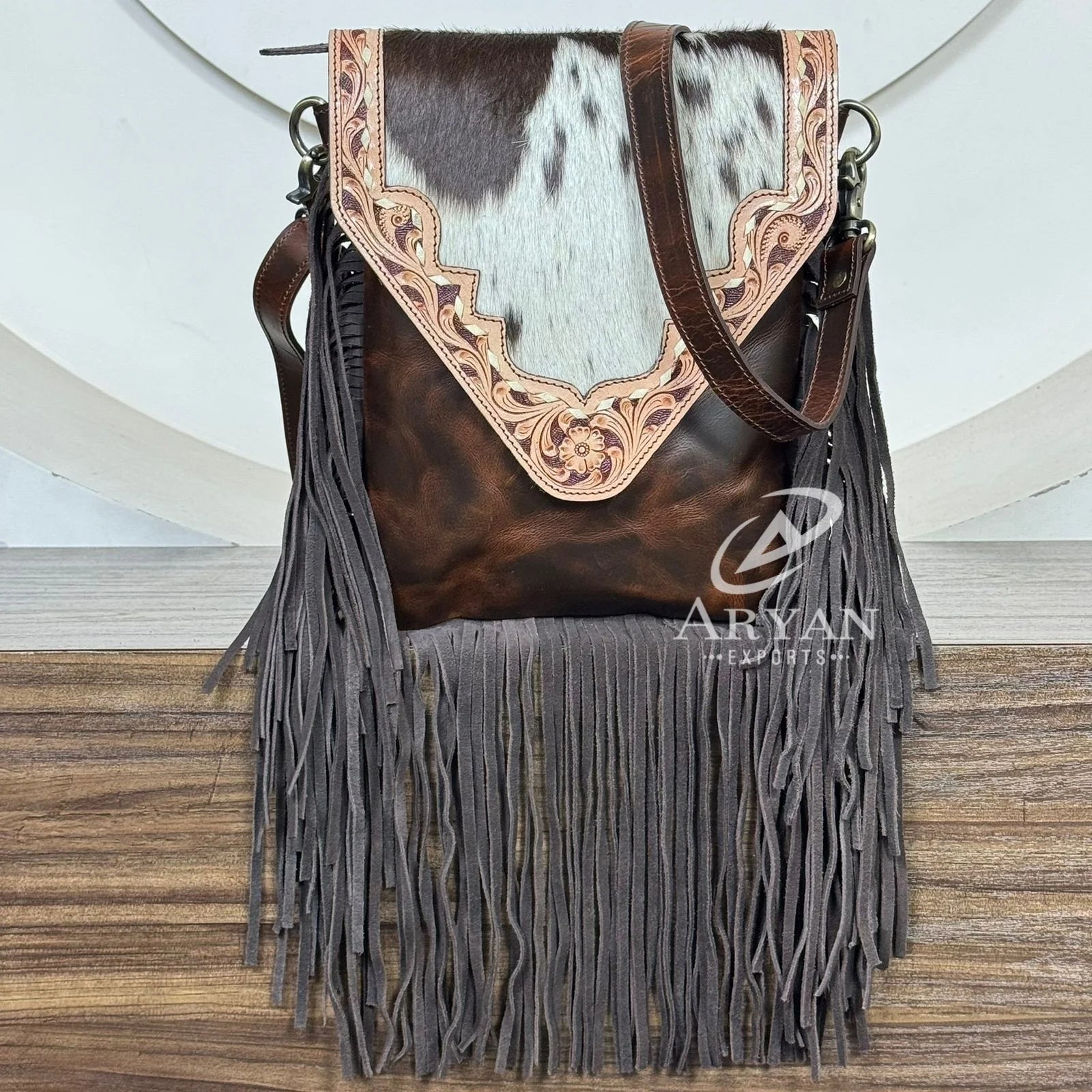 Vintage floral tooled brown cowhide leather fringe crossbody bag with genuine leather trim. Designer shoulder handbag.