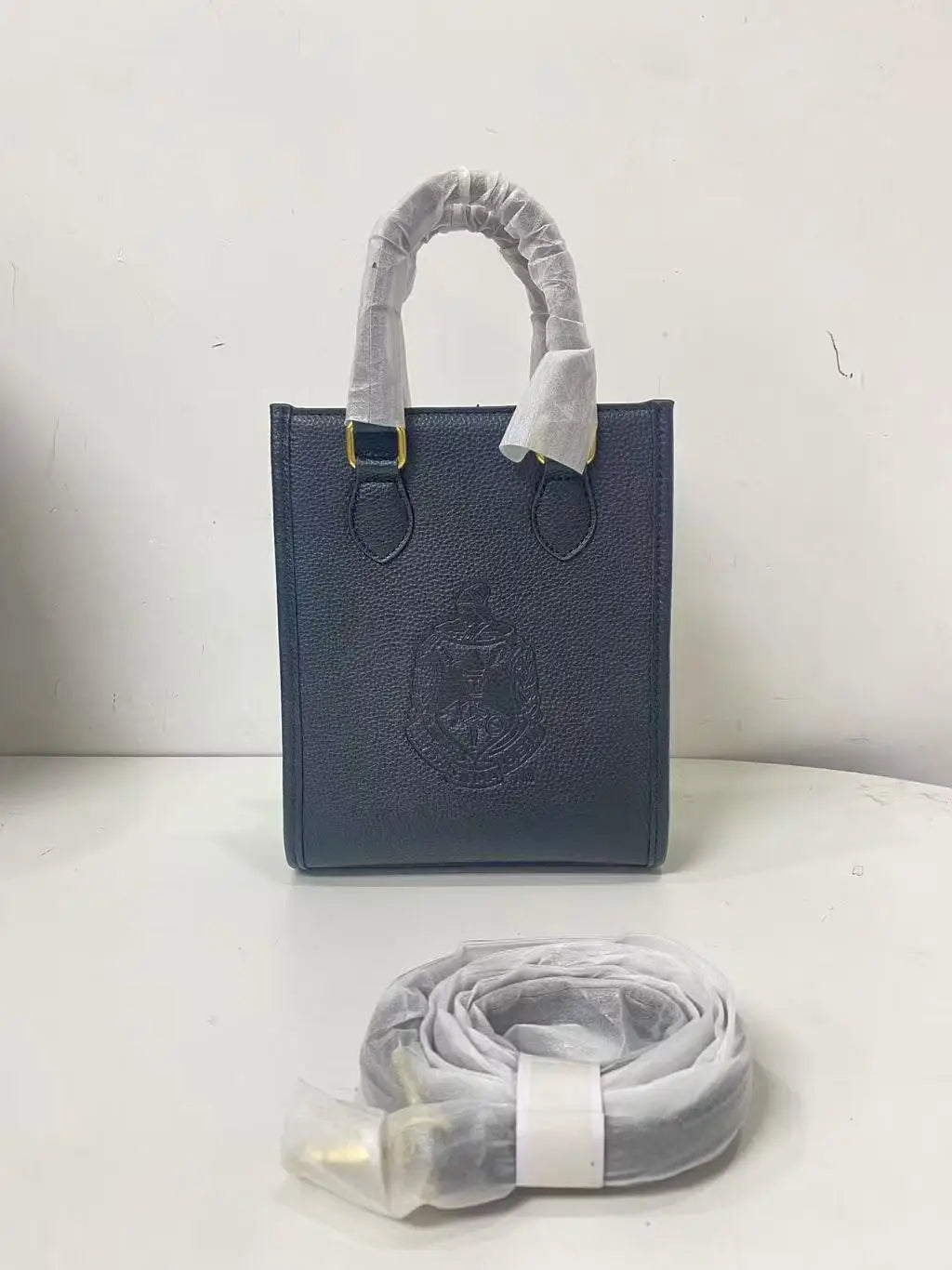 Black genuine leather crossbody bag with Order of the Eastern Star embossed design and gold hardware. Designer handbag.