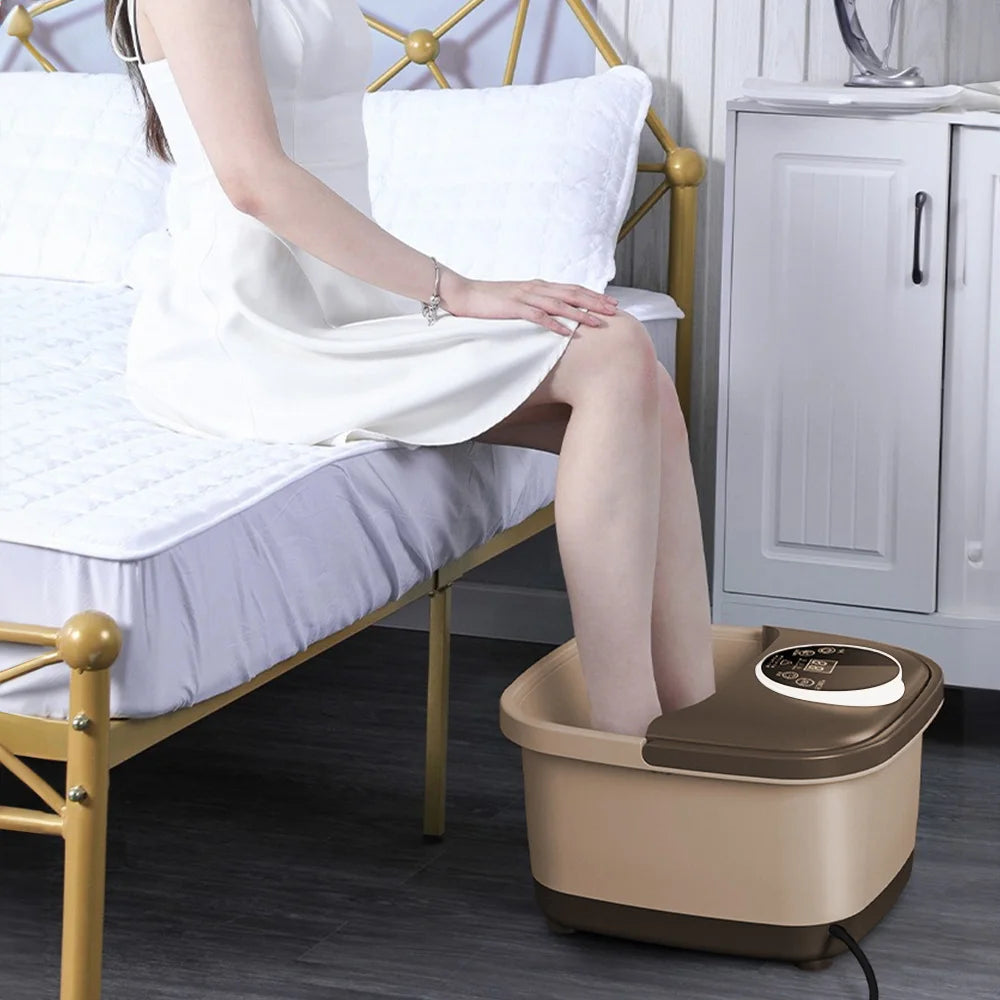 Woman in white dress using a beige and brown, rectangular automatic electric foot spa massager with digital control.