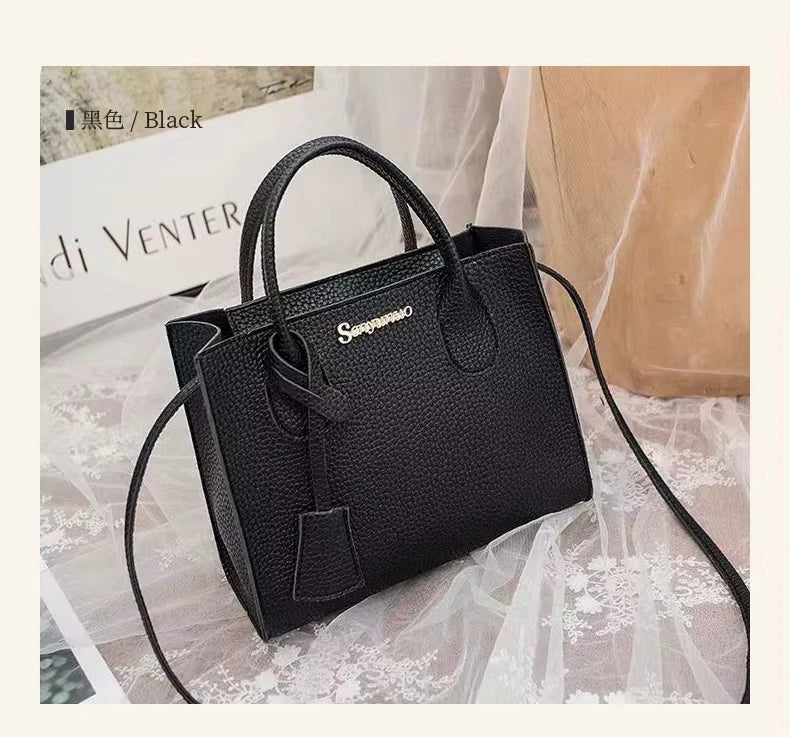Black luxury designer handbag in waterproof pebbled PU leather, featuring dual handles, shoulder strap, and logo plate.