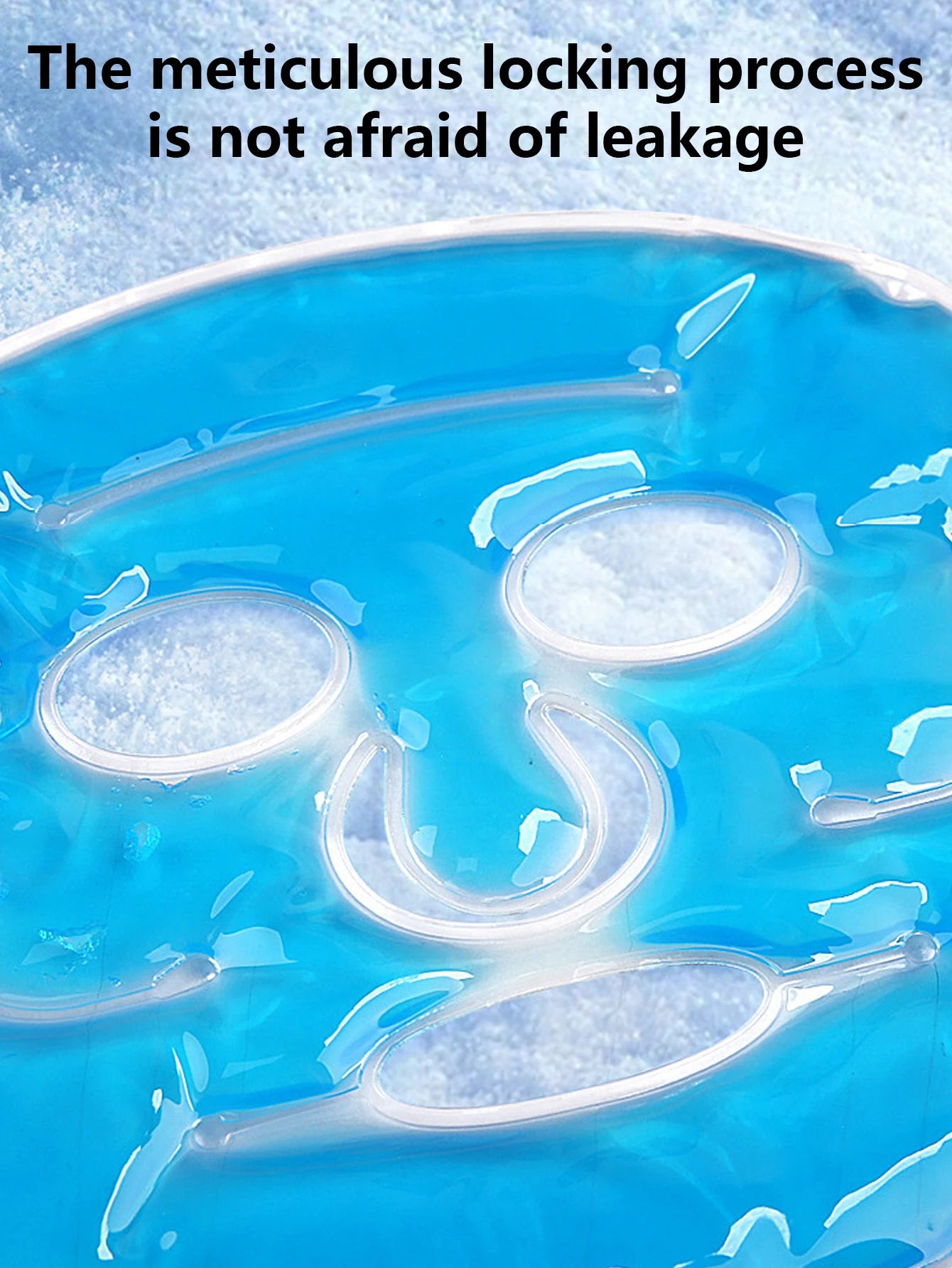 Close-up of a blue gel face mask with a reinforced, leak-proof sealed edge, placed against a snowy background.