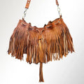 Tan leather boho bucket bag featuring long fringe, tassel detail, and adjustable shoulder strap.
