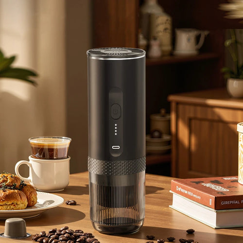 Portable black cylindrical coffee maker with a transparent base, LED power indicator, and USB-C port on wood table.
