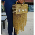 Gold metal box clutch with teardrop crystals, intricate beadwork, and long fringe tassel. Premium designer handbag.