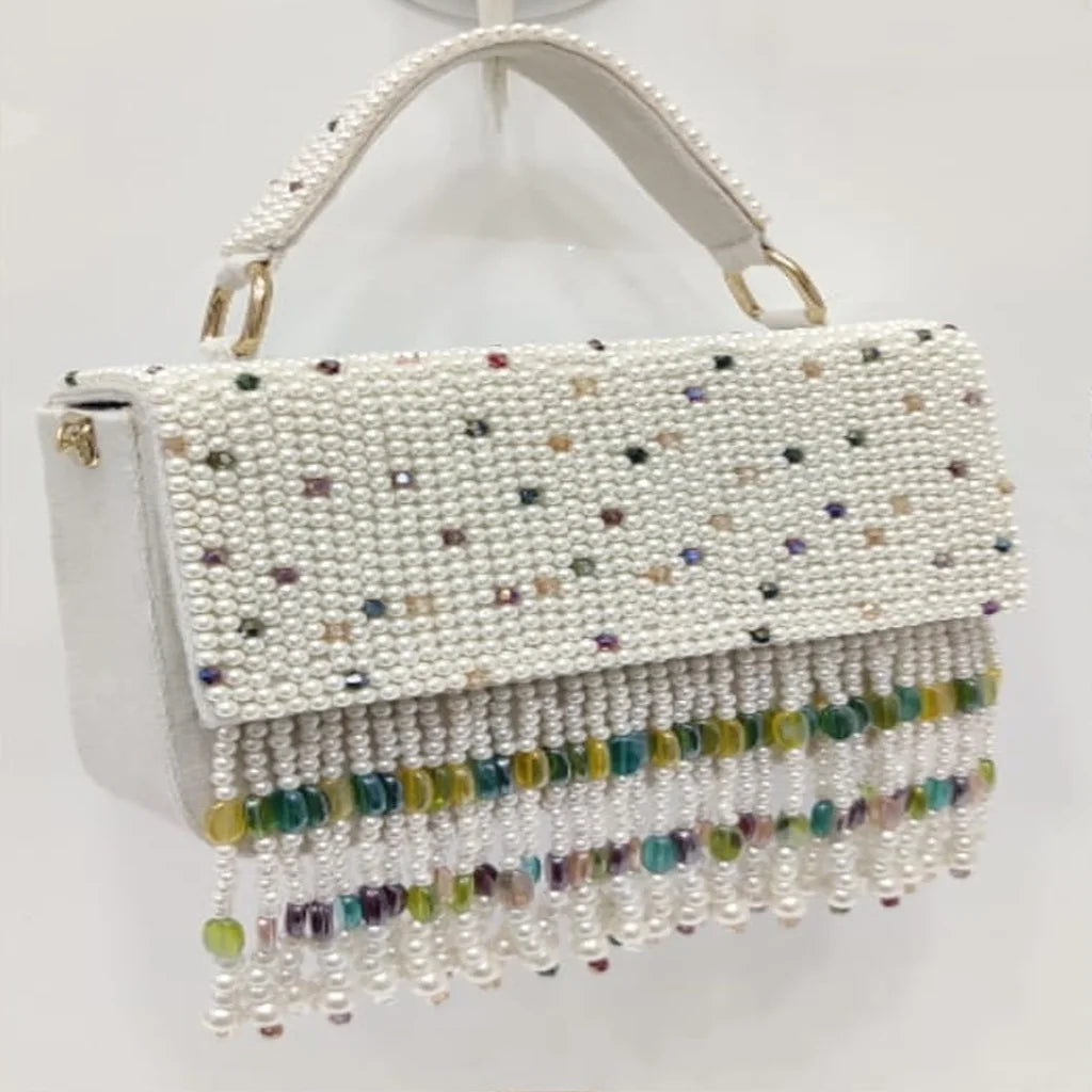 Luxury white pearl handbag with colorful crystal accents and long beaded tassel fringe for evening or wedding wear.