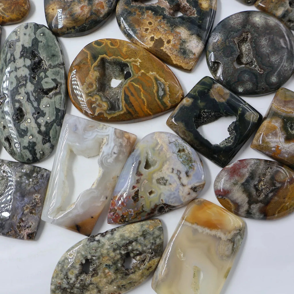 Assorted ocean jasper druzy cabochons, including oval, teardrop, and rectangle shapes