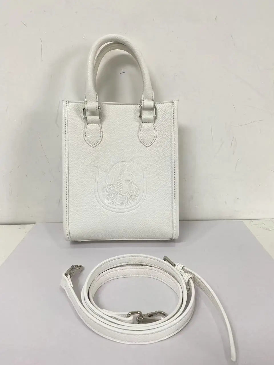 White genuine leather crossbody bag with Order of the Eastern Star embossed design and detachable shoulder strap.