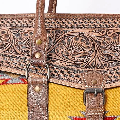 Brown hand-tooled leather and yellow Aztec saddle blanket sling bag with floral engraving and antique brass hardware.