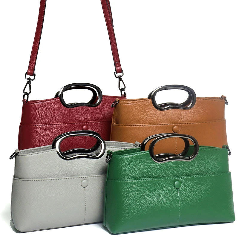 Designer handbags in red, tan, grey, and green pebble PU leather with metal ring handles and crossbody straps.