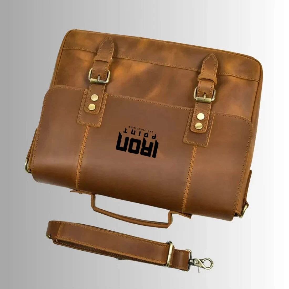 Brown leather business laptop briefcase with buckle straps, top handle, and detachable shoulder strap. #Trunks