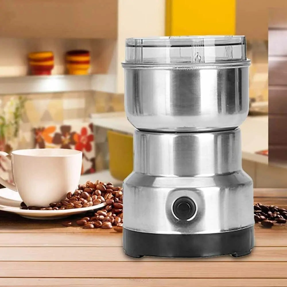 Compact stainless steel electric coffee bean grinder with a clear lid, ideal for home kitchens.