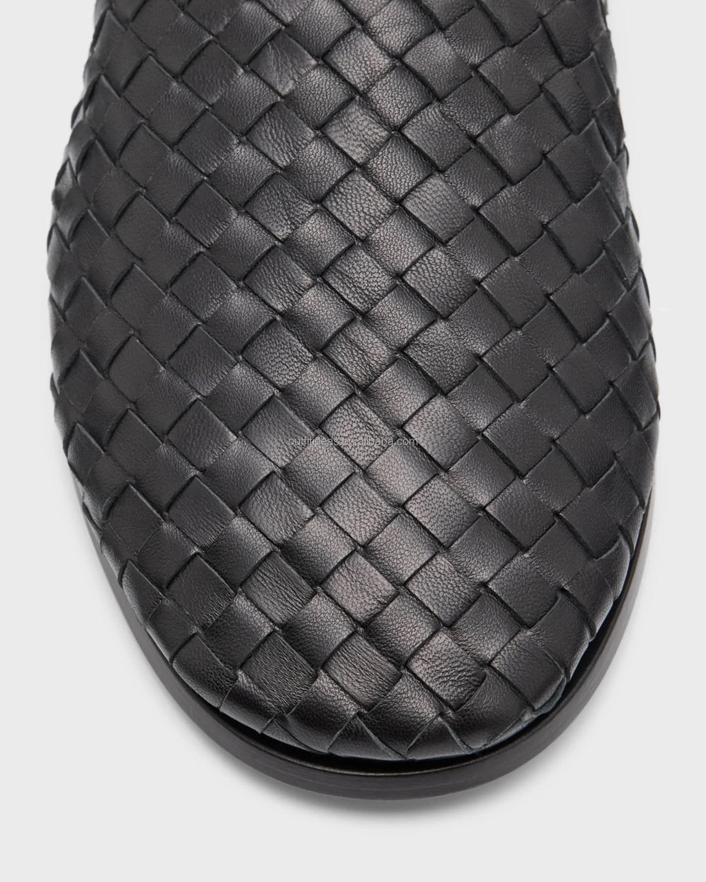 Luxury black woven leather women's loafer with premium braided texture and durable flat rubber sole.