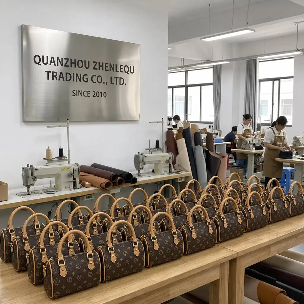 Brown logo-print leather trunks with tan handles, organized on a factory workbench in a leather handbag workshop.