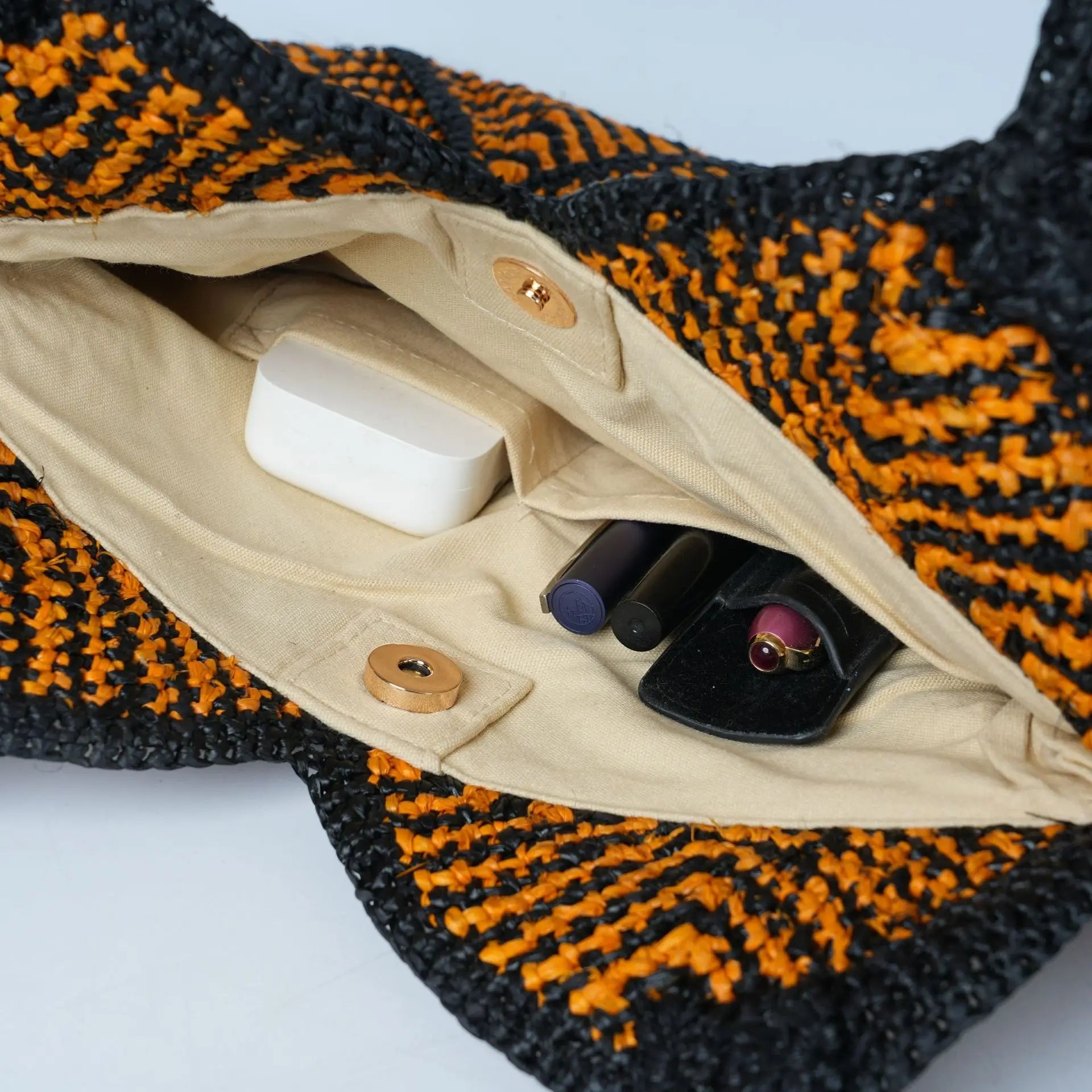 Black and orange boho crochet summer tote bag, ecofriendly fabric interior with magnetic snap and pocket organizers.