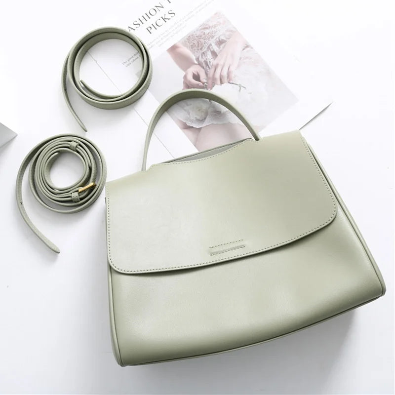 Minimalist sage green leather designer handbag with top handle and detachable shoulder strap in a Korean style.