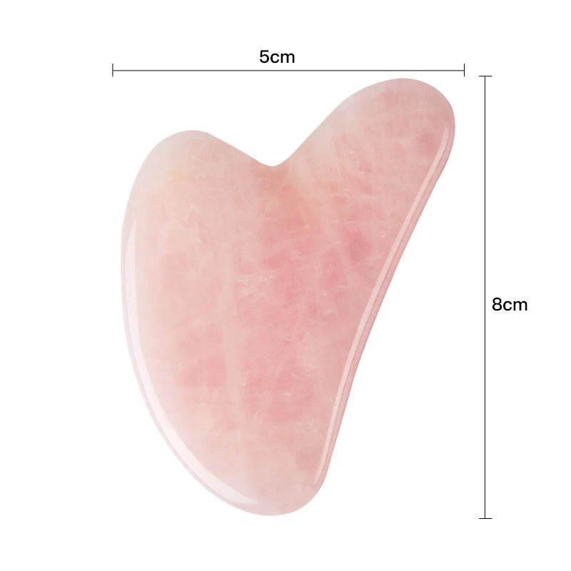 Heart-shaped light pink rose quartz gua sha tool, 5cm wide by 8cm tall, with a smooth, polished stone finish.