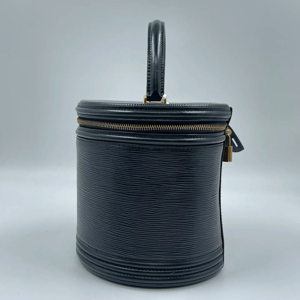 Luxury pre-owned black leather cylinder-shaped vanity handbag with top handle, zipper closure, and gold-tone hardware.