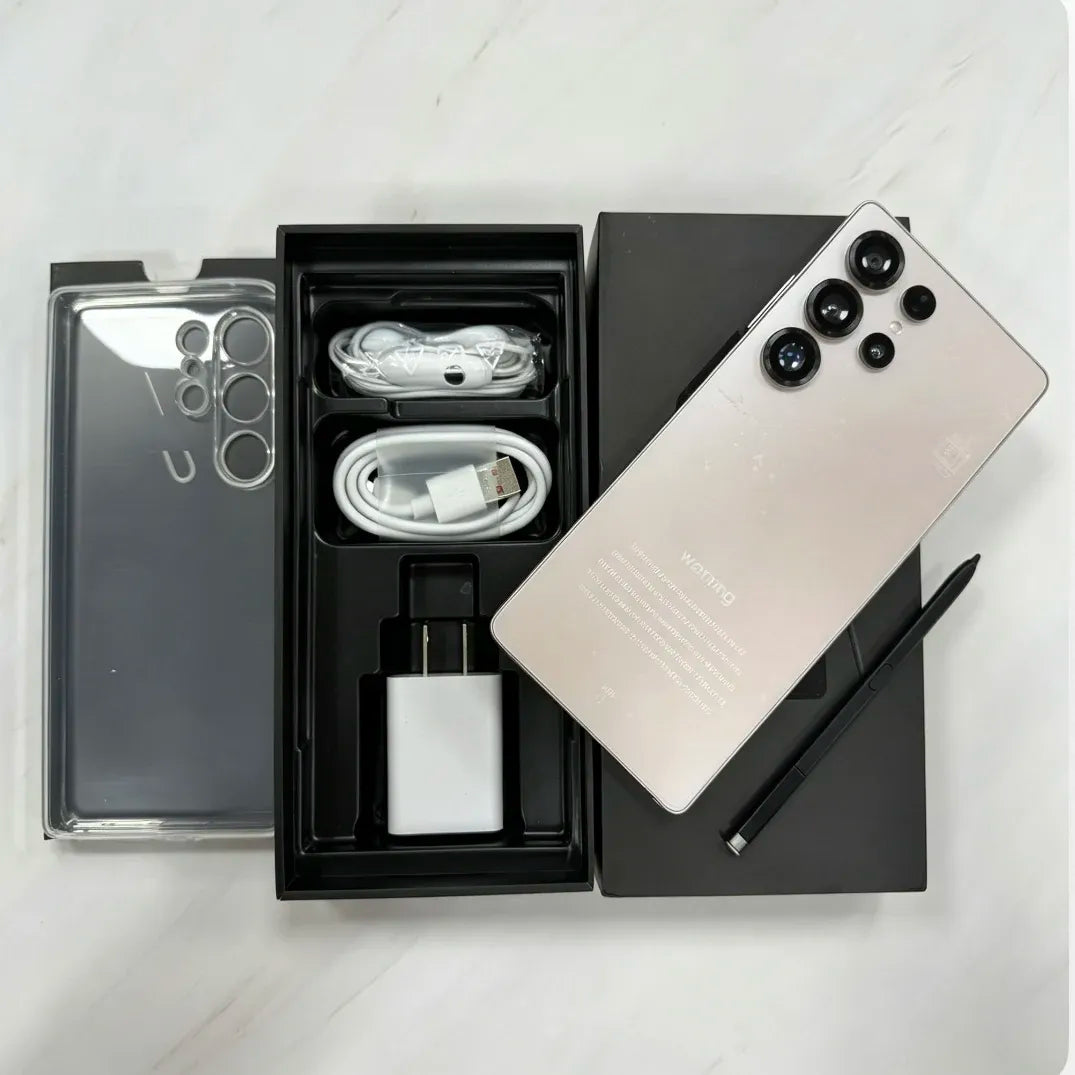 Gold smartphone with cables and charger in open box, accessories visible.
