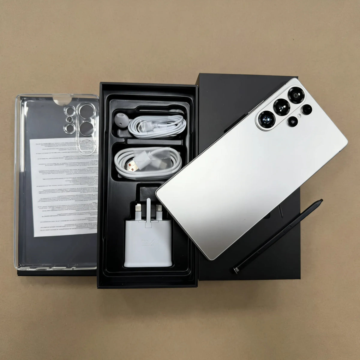 Unlocked 5G smartphone unboxed: white phone with rear camera array, accessories included