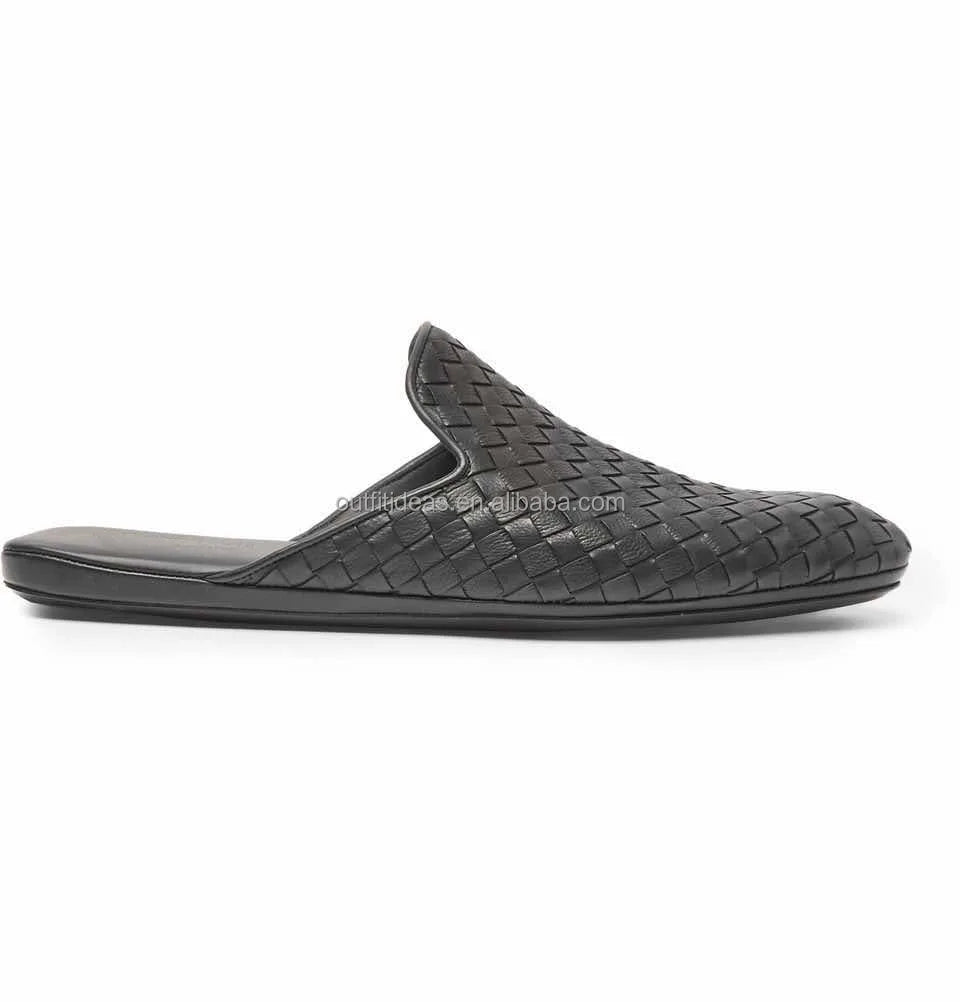 Black woven leather women’s mule loafer with a flat sole and slip-on luxury design.