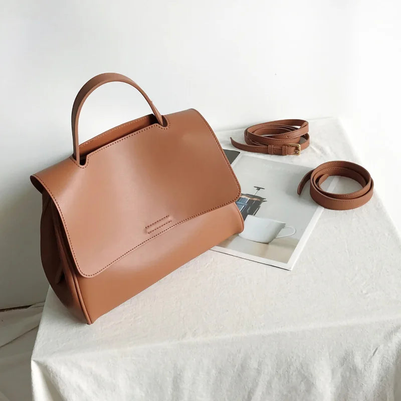 Minimalist brown leather designer handbag with top handle and detachable strap, Korean-style simple messenger bag.