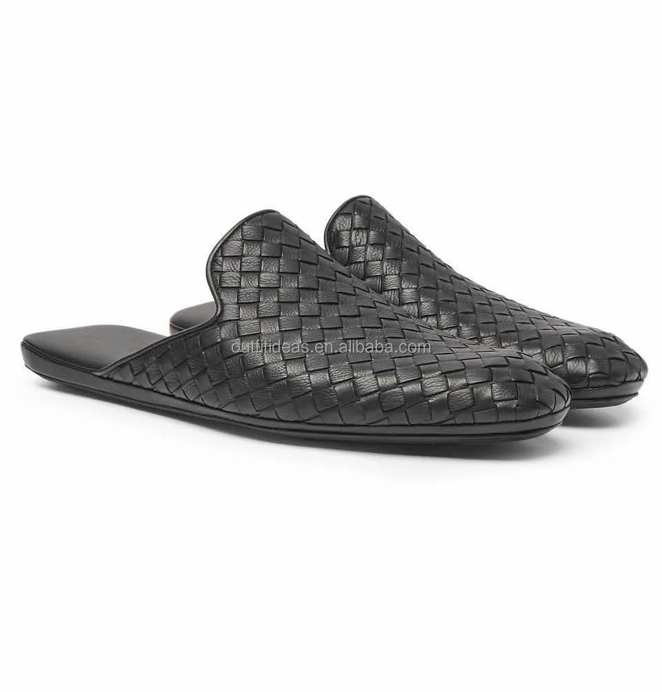 Luxury black woven leather mule loafers with a flat sole and slip-on style for women.
