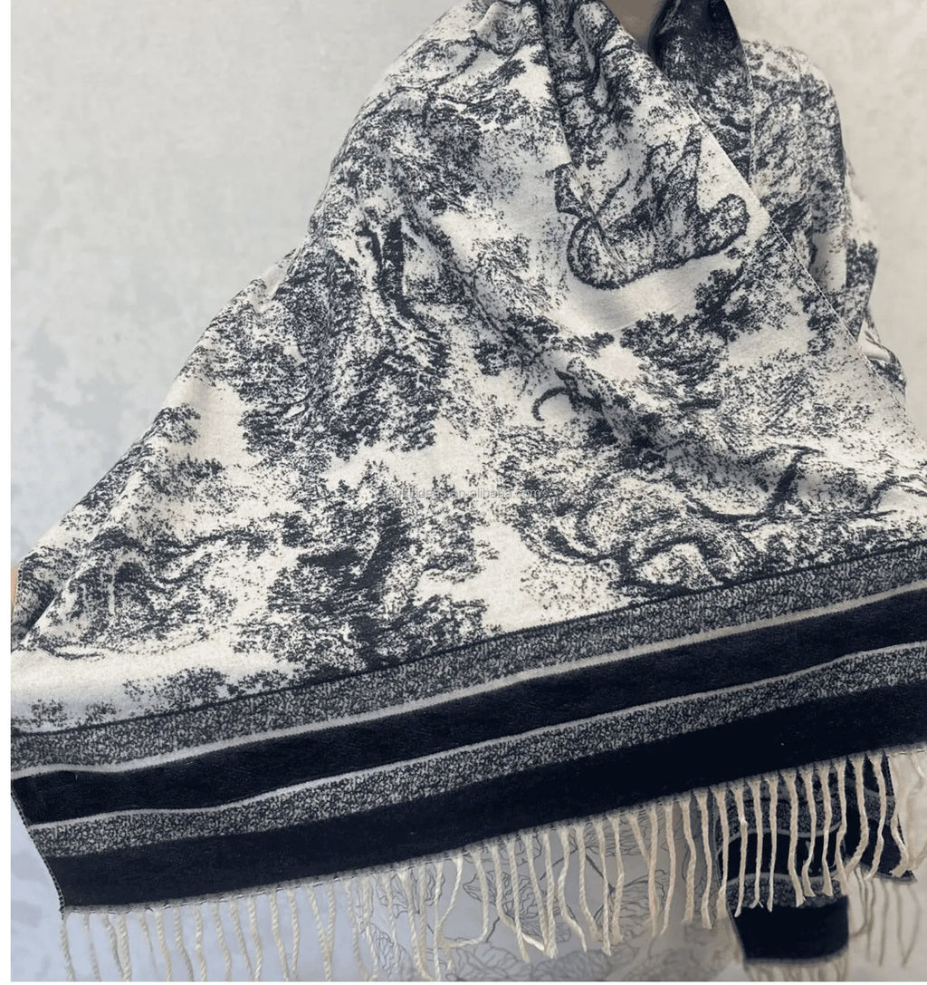 Luxury silk scarf, rectangular with black and white toile de jouy pattern, striped border, and white fringe trim.