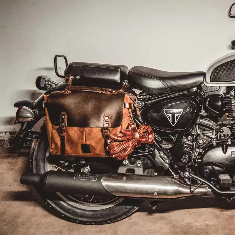 Retro waterproof motorcycle saddle bag in oil wax canvas and brown crazy horse leather mounted on a Triumph bike.
