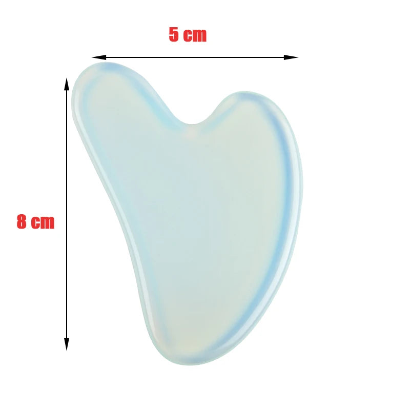 Light blue, translucent heart-shaped stone gua sha facial massage tool measuring 5cm by 8cm.