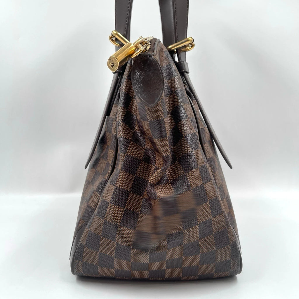 Luxury designer handbag in brown checkered canvas with leather straps and gold padlock hardware, unisex shoulder bag.