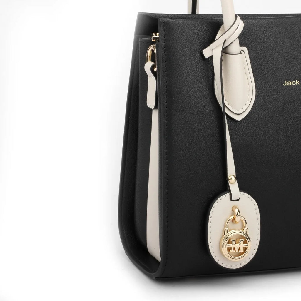 JACK CAPTAIN black and white leather designer tote bag with gold logo charm and structured silhouette.