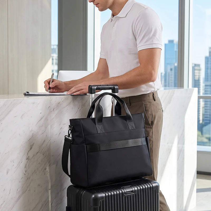 Mark Ryden black waterproof designer briefcase tote with top handles and shoulder strap for men's business travel.