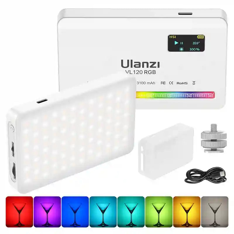 White VL120 RGB LED video light with digital display, silicone diffuser, charging cable, and cold shoe mount.