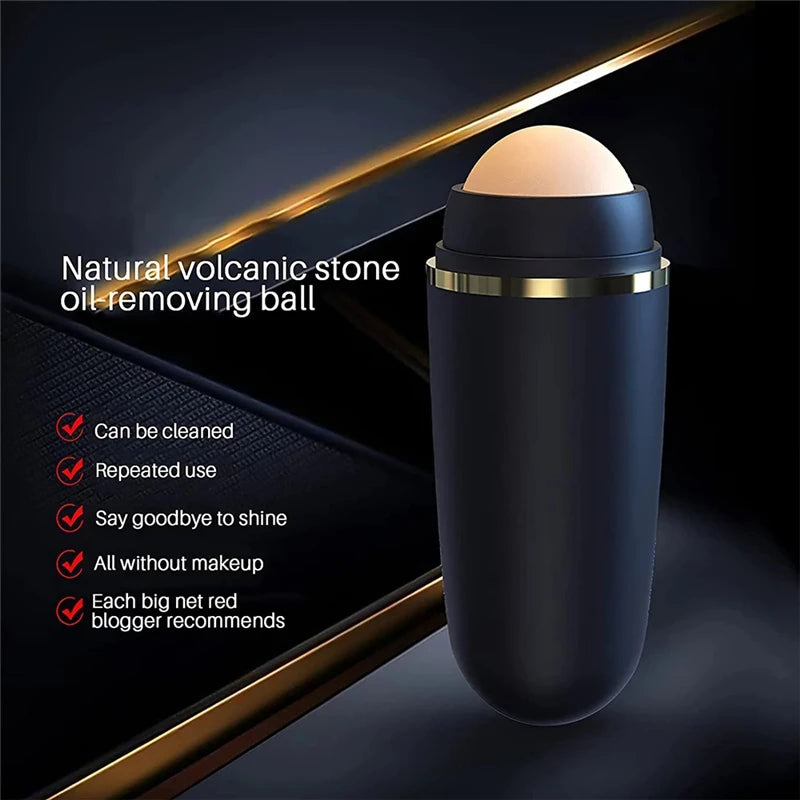 Black cylindrical facial oil roller with a beige volcanic stone ball and gold trim detail on a dark background.