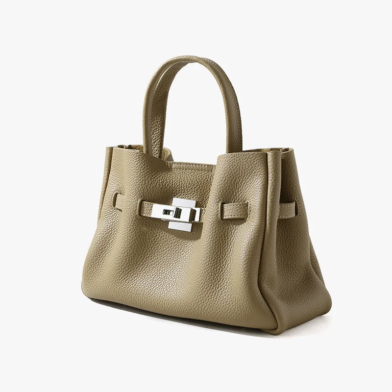 Taupe genuine leather satchel, old money aesthetic with silver metal lock closure, top handle, and pebbled texture.