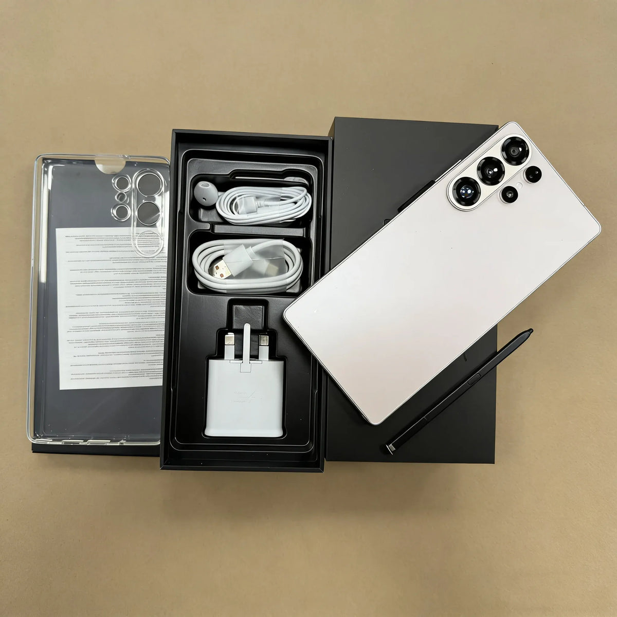 S26 Ultra smartphone with white back, open box with charging cable and adapter