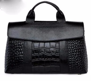 Black genuine leather designer handbag with mixed crocodile-embossed texture, top handle, and flap closure.