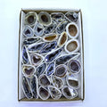 Agate geode crystal slice assortment in a gift box with varied dark gray stones