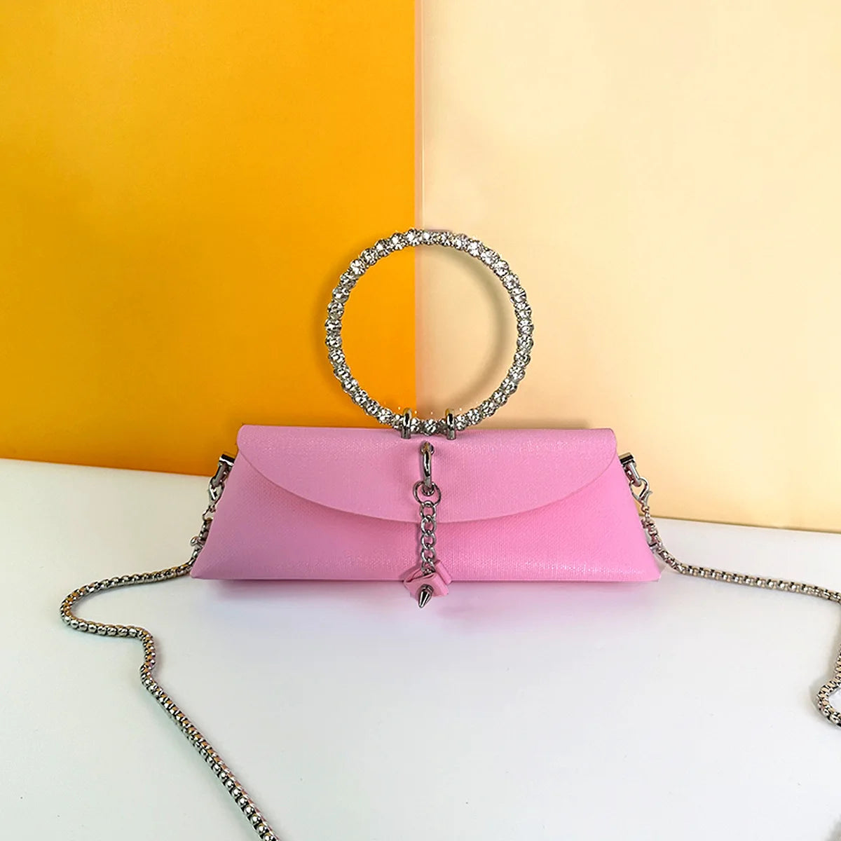 Pink PU leather evening clutch with crystal ring handle, silver chain strap, and elegant wedding trunk design.