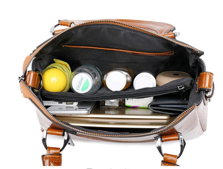 Tan genuine cow split leather handbag interior showing organized compartments, pockets, and daily essentials.