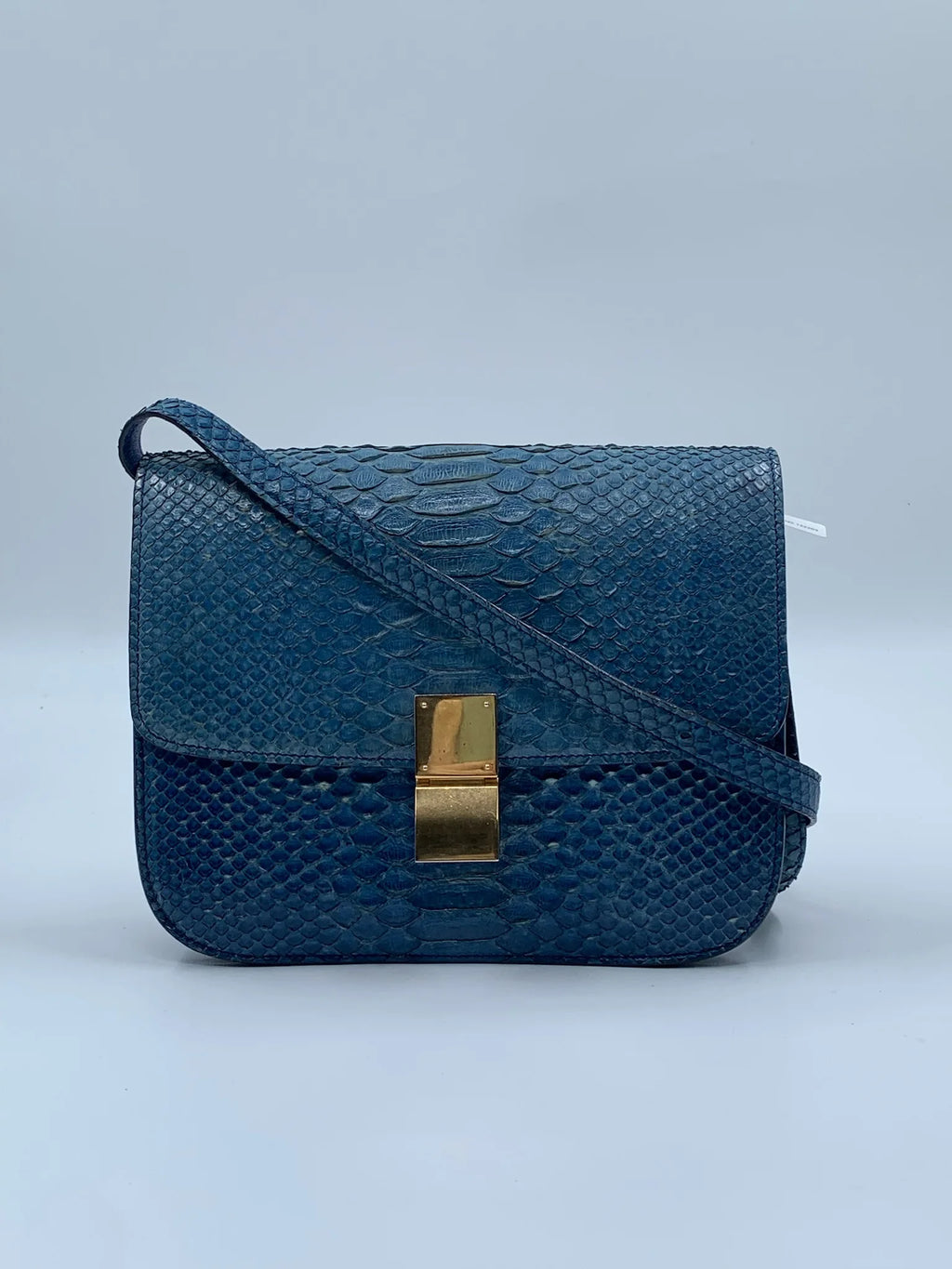 Luxury pre-owned blue snakeskin square shoulder bag with gold clasp and crossbody strap. Designer handbag vintage style.