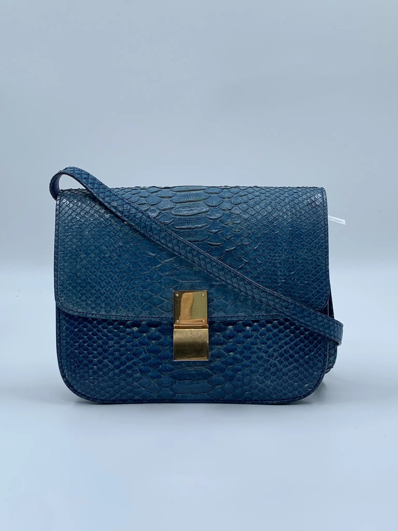 Luxury pre-owned blue snakeskin square shoulder bag with gold clasp and crossbody strap. Designer handbag vintage style.