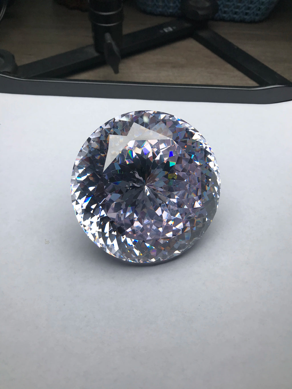 Large round brilliant-cut cubic zirconia gemstone, white, facets show strong reflections